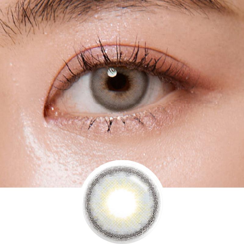 Macro photograph of a dark brown eye with clean makeup showcasing the Shade Grey prescription color contact lens, highlighting the multicolored detail and natural effect
