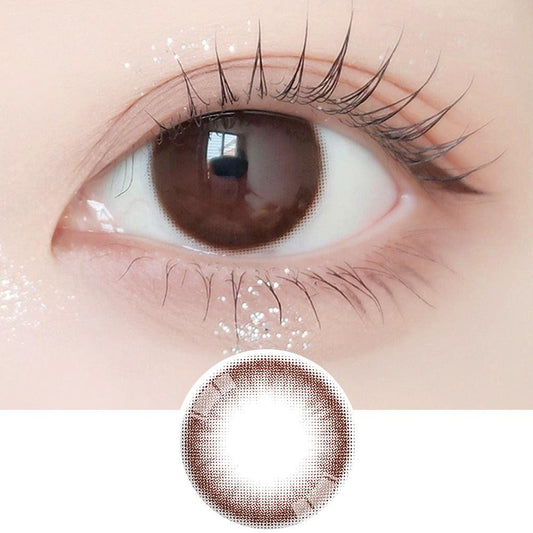 Close-up shot of model's eye adorned with Ann365 JUST Choco daily color contact lenses with prescription, paired with clean-girl eye makeup, showing the brightening and enlarging effect of the circle contact lens on dark brown eyes, above a cutout of the contact lens with limbal ring on a white background.