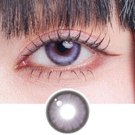 Close-up shot of model's eye adorned with Dollring Poppy Violet prescription circle contact lenses, complemented by clean eye makeup, showing the brightening effect of the prescription cosmetic contact lens on dark brown eyes.