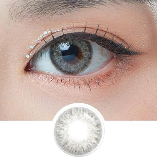 Macro photograph of a dark brown eye with clean makeup showcasing the Sephia Grey prescription color contact lens, highlighting the multicolored detail and natural effect