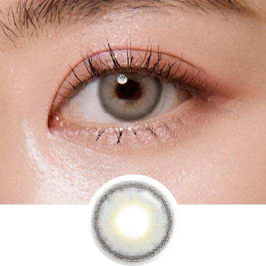 Macro photograph of a dark brown eye with clean makeup showcasing the Shade Grey prescription color contact lens, highlighting the multicolored detail and natural effect